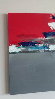 Large canvas painting titled 'The Inner Sunset,' featuring an abstract representation of a sunset and clouds. The artwork blends vibrant orange, blue, and grey tones, evoking the serene and dynamic atmosphere of a sunset sky.